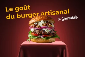 Image d'un burger posé sur une table, avec un texte "le goût du burger artisanal Grenoble"